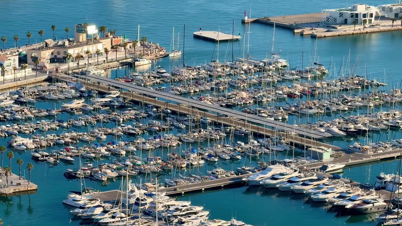 A breathtaking aerial view captured of a vibrant marina, bustling with luxury yachts and picturesque waters