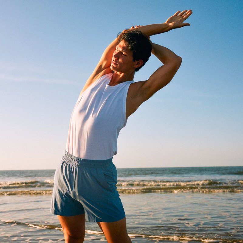 A man stretching by the beach