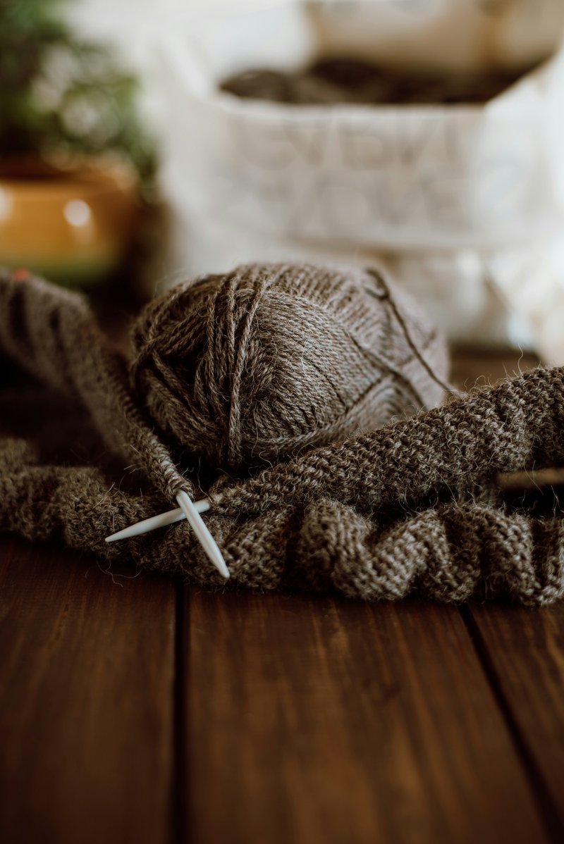 Knitting with dark brown yarn (Photographer: Oksana Maselko)