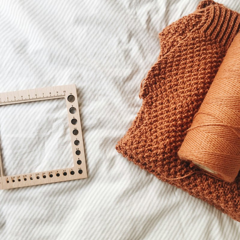A knitting gauge with a knitted sample (Photographer: rocknwool)