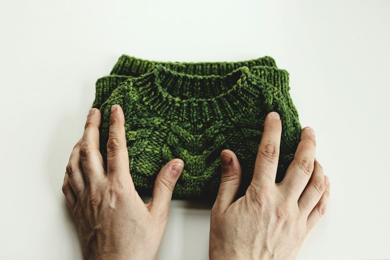 Folding a small knitted garment (Photographer: Ksenia Makagonova)