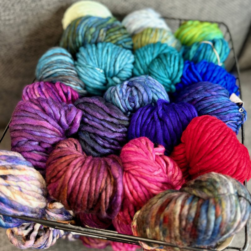 Skeins of Malabrigo Rasta hand-dyed yarn in basket (Source: Thread Collective)