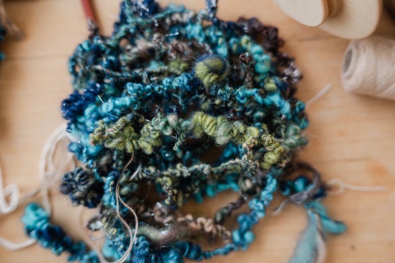 Handspun variegated boucle yarn in shades of blues and greens (Source: Samantha Gehrmann)