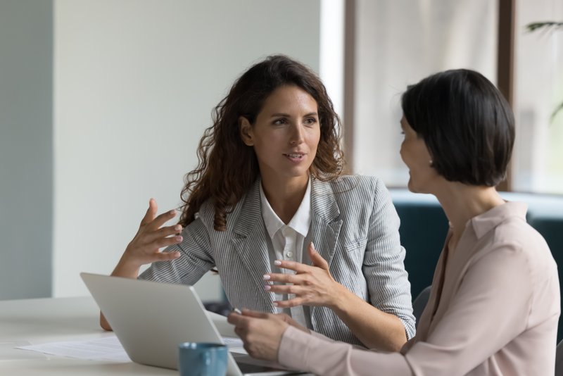 female colleagues talk through their sales presentations