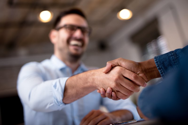 men shake hands following a sales presentation