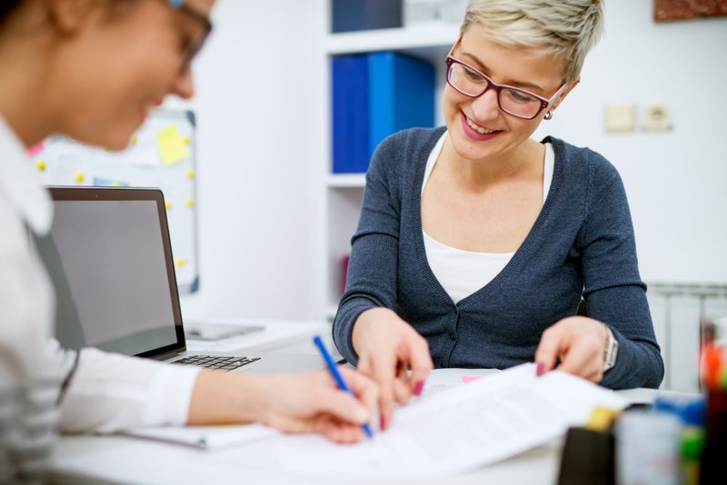 woman signs a contract after a successful sales presentation