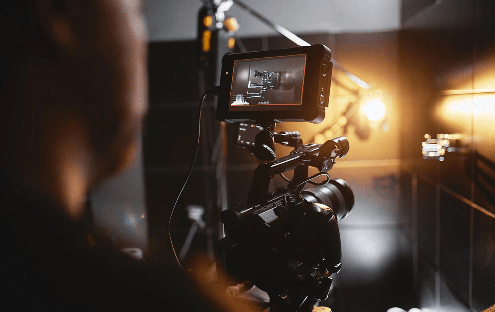 Event video production crew member checking camera framing