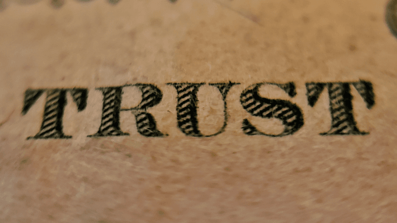 The word trust printed on a yellowed certificate.