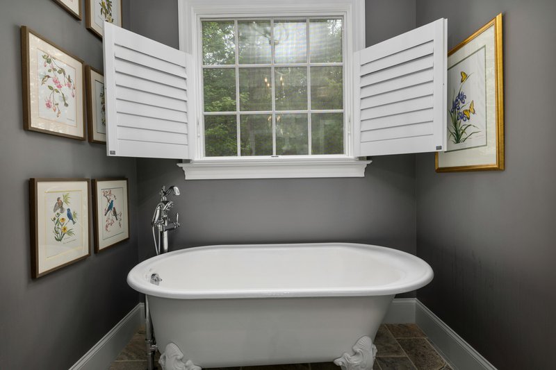 Rustic bathroom with a classical bathtub.