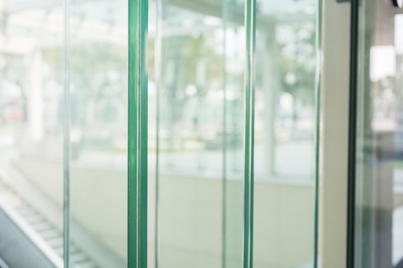 Sunny modern office interior with tempered glass panels