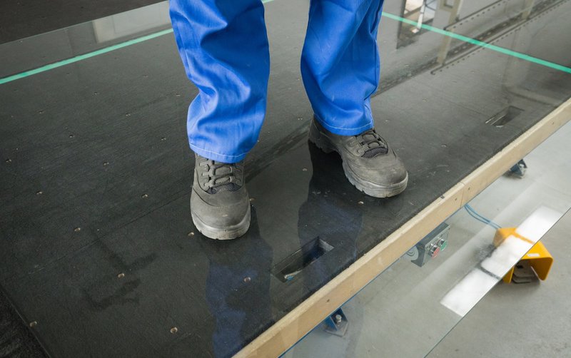 Man stepping on durable tempered glass.