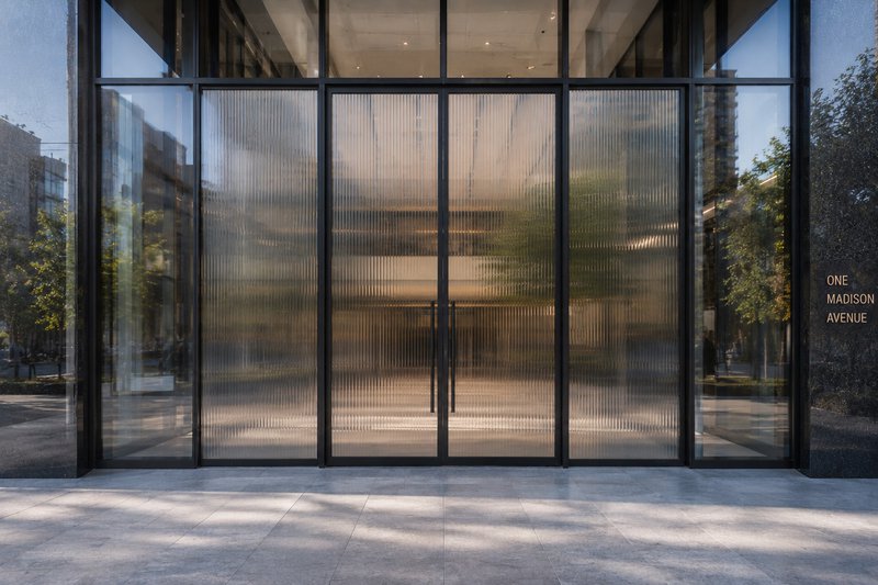 Commercial building exterior showing reeded glass doors.