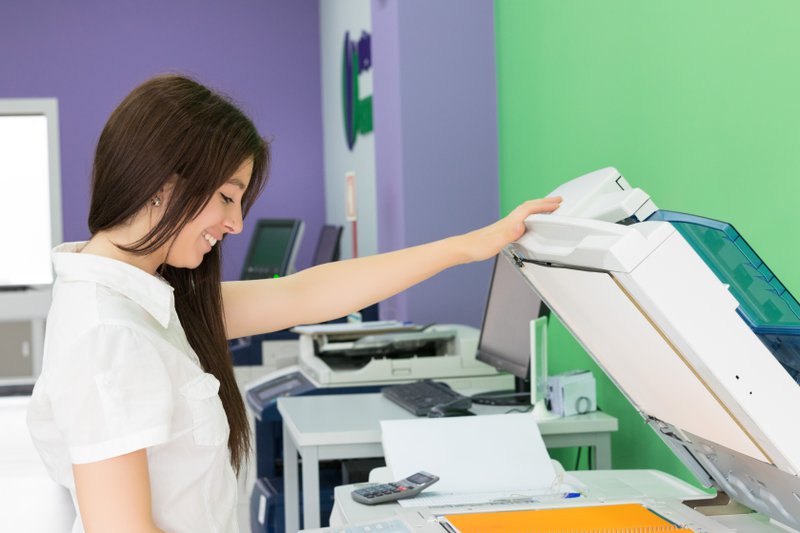 a woman using the photocopier-printer