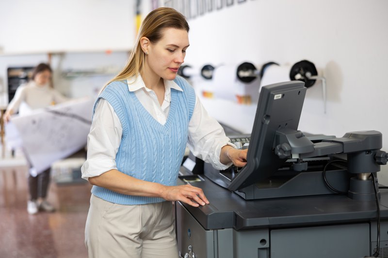 a worker using the photocopier-printer