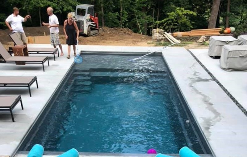 a newly installed classic fiber glass inground pool