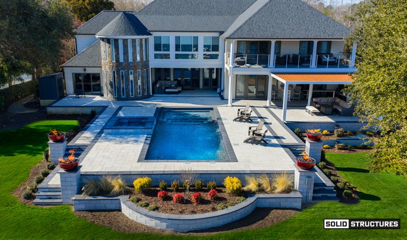 An above-ground fiberglass pool installation, pool deck included.