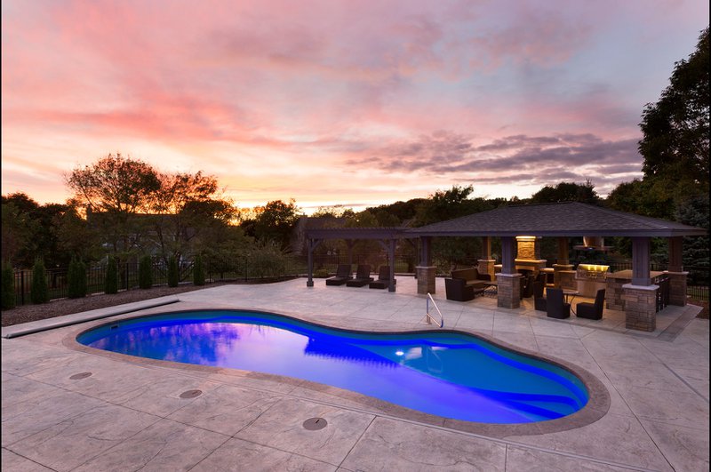 A fiberglass above-ground pool with an elevated deck.