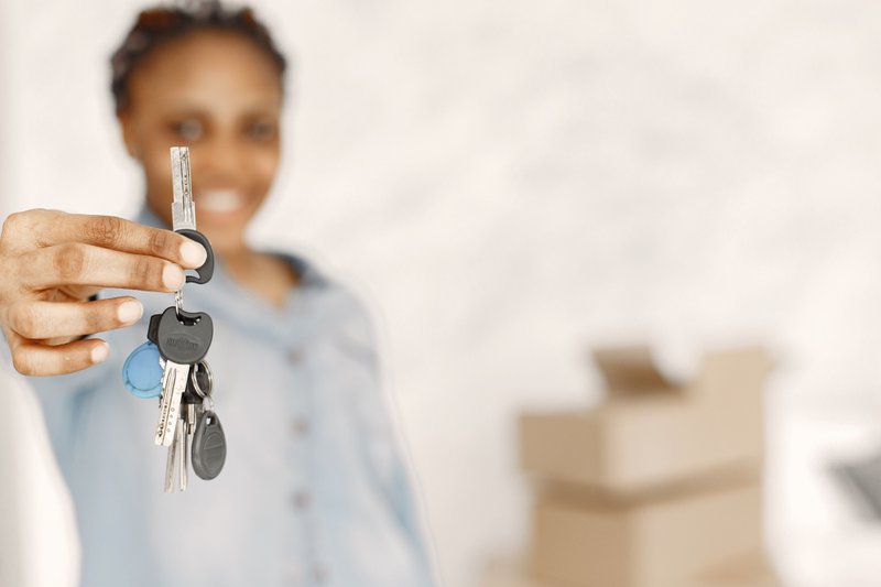 A woman holding her housekey from a first-time homebuyer credit option.