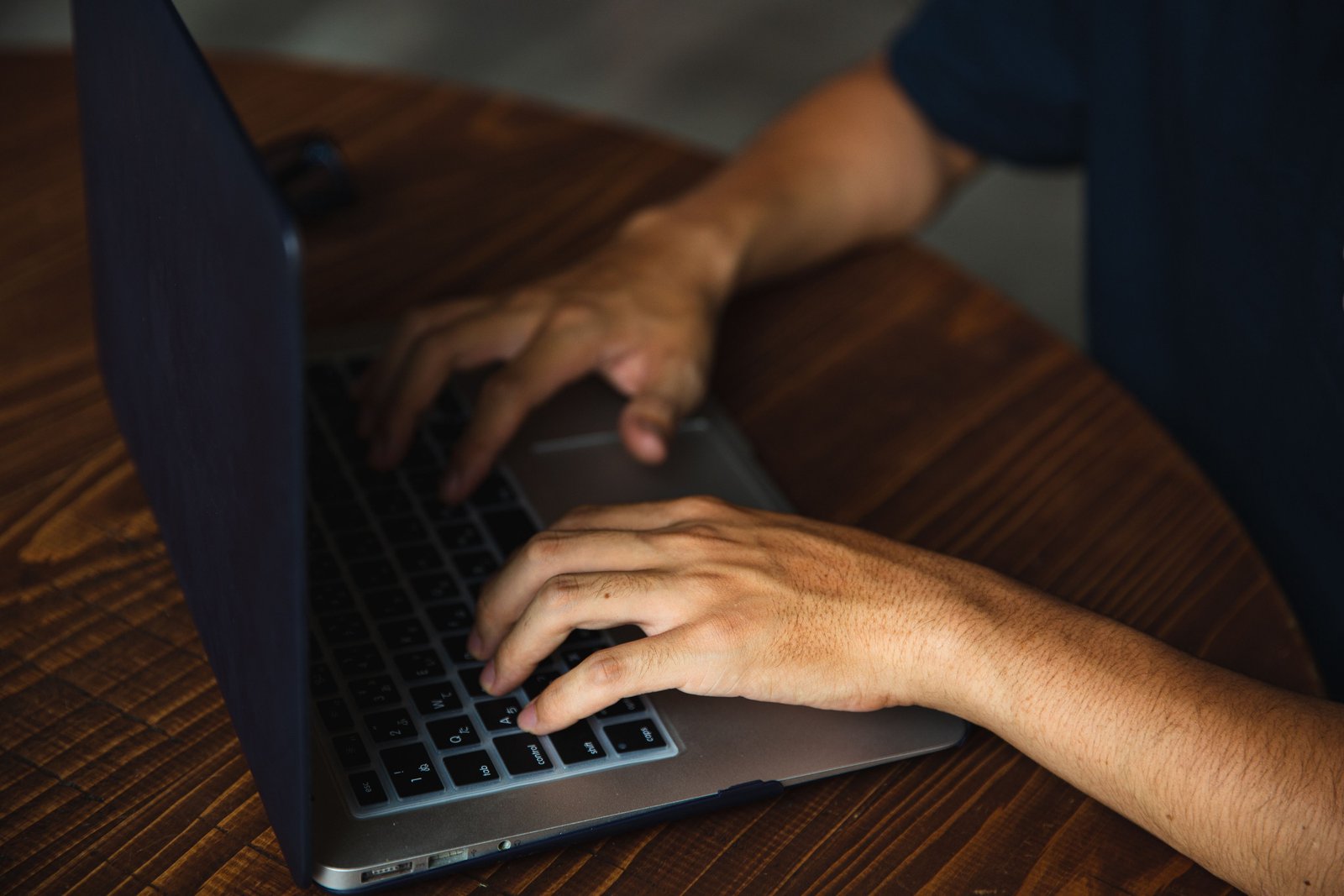 A man searching how to get a copy of naturalization certificate online with a laptop.