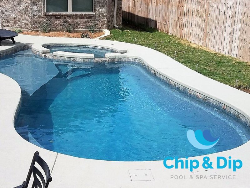 Fiberglass vs concrete pool in a residential backyard.