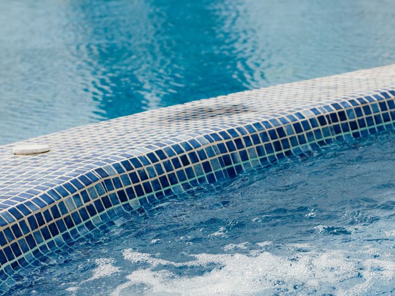 A pool surface due for fiberglass pool resurfacing.