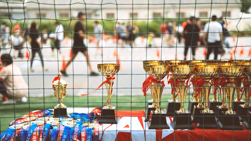 red and gold trophy on blue and red table