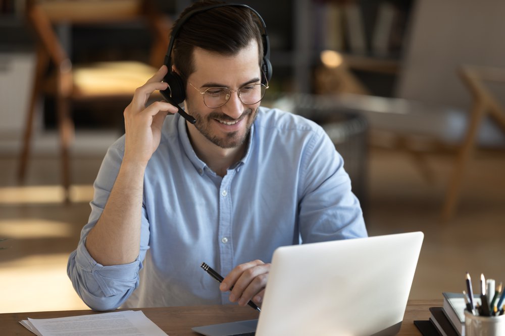 Young adult male providing virtual assistant services. Young adult male providing virtual assistant services.
