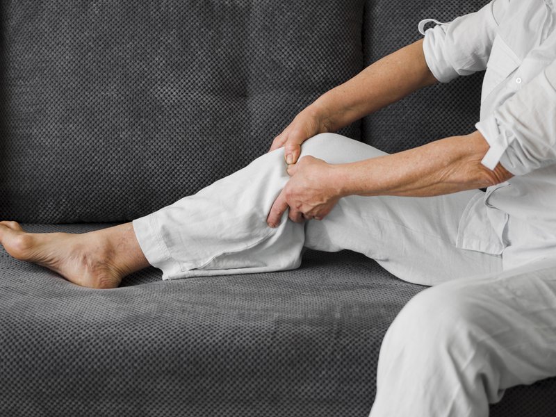 Older adult experiencing pain after knee replacement surgery.
