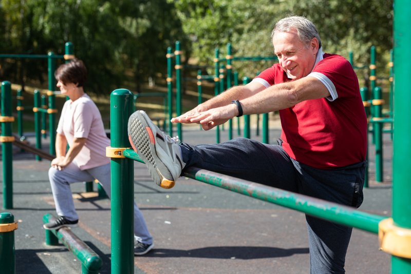Senior man doing knee strengthening exercises before total knee replacement surgery.