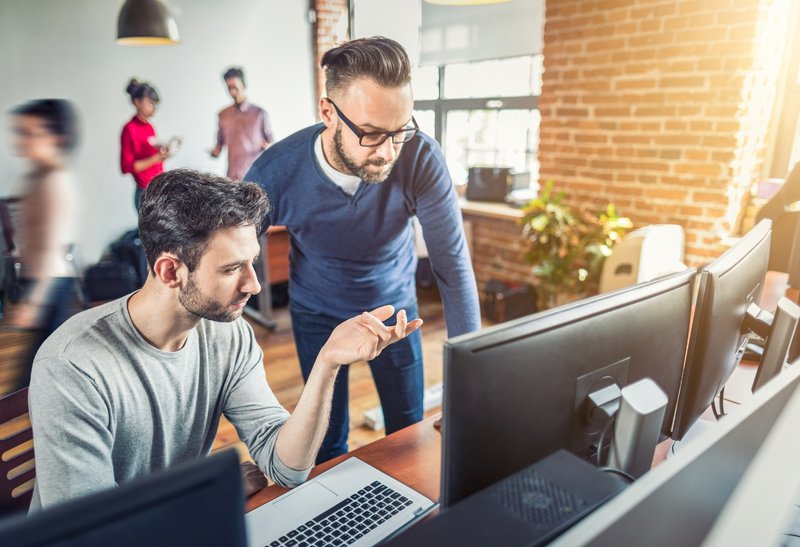 Agency employees studying association advertising revenue