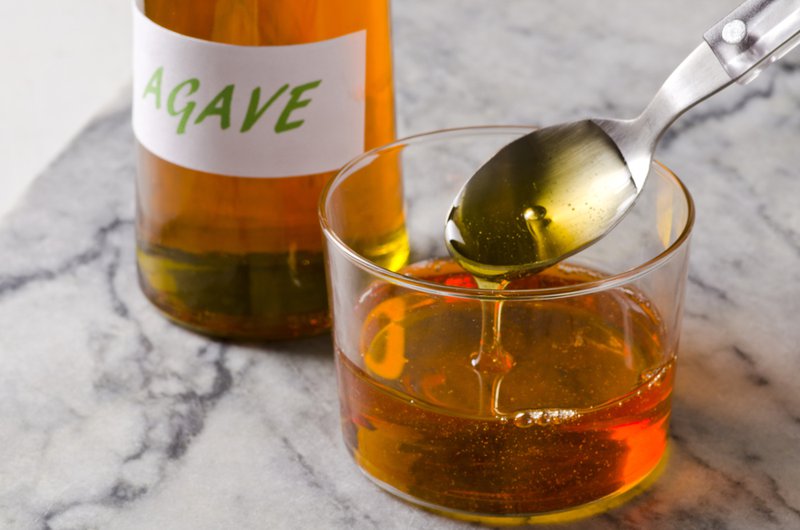 Agave products, syrup spilling from a spoon.