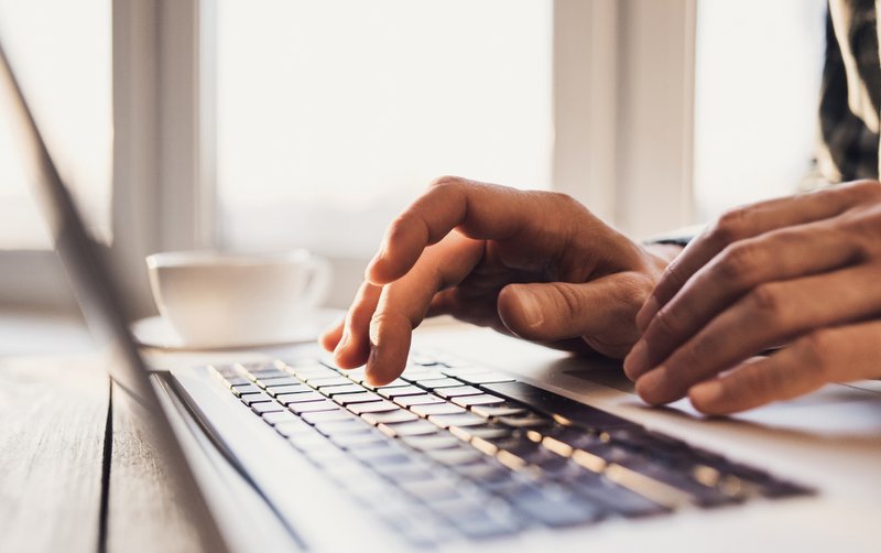 Hands typing on keyboard