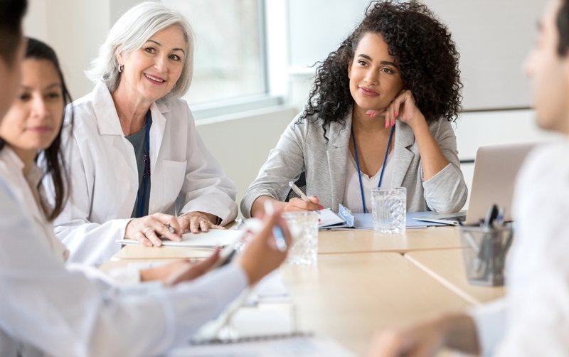 Hospital staff discussing non-dues revenue for medical associations