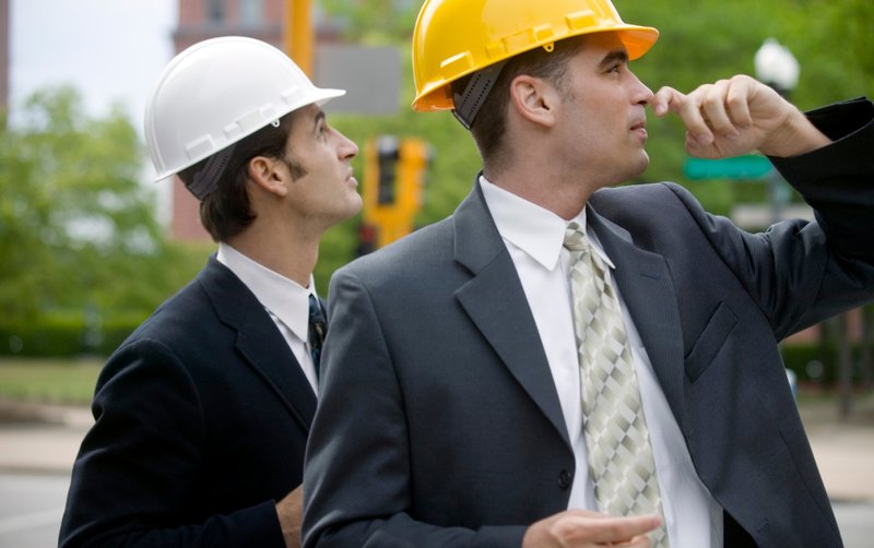 Two real estate developers wearing hard hats