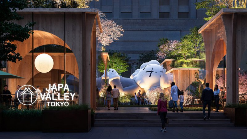 KAWS sculpture installed among timber pavilions and cherry blossoms at Japa Valley Tokyo