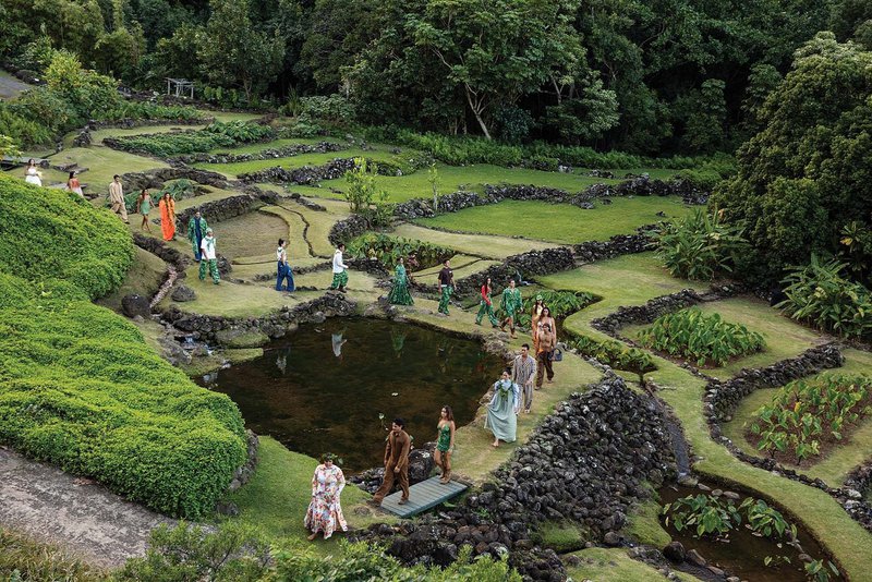 Models in Hawaiian design walking through a terraced loʻi at a Rocket Ahuna runway show