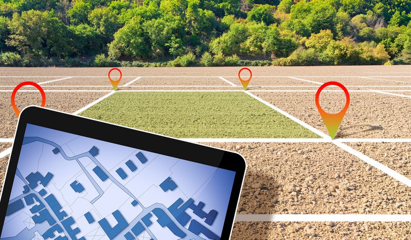 Land plot management - real estate concept with a vacant land on a plowed agricultural field available for building construction and housing subdivision for sale, rent, buy or investment