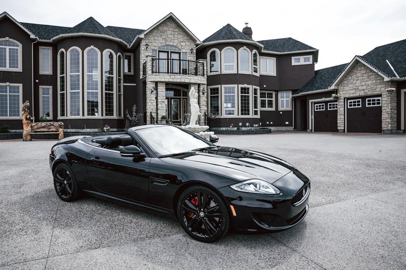 black convertible coupe parked near house
