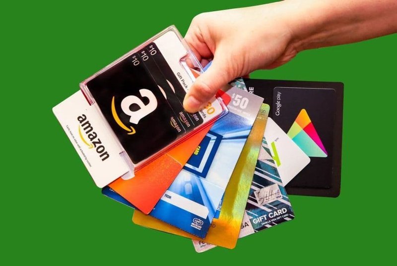 hand holding multiple gift cards