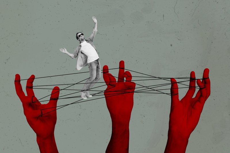 A person being metaphorically manipulated, much like how dark patterns and UX decisions can change your behaviour.