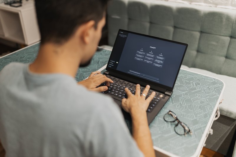 A person looking at an AI chat screen while debating whether to rely on it for coding help