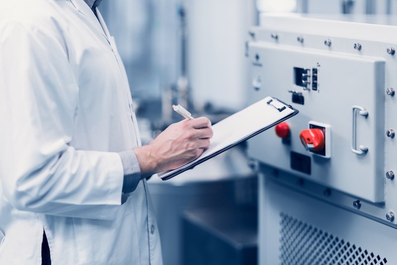 Pharmaceutical worker preparing machines for large scale production