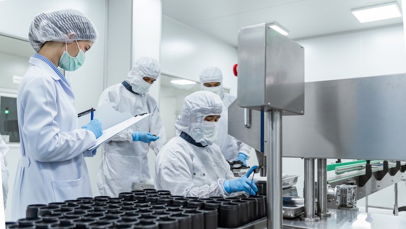 Pharmaceutical production crew, following cGMP regulations