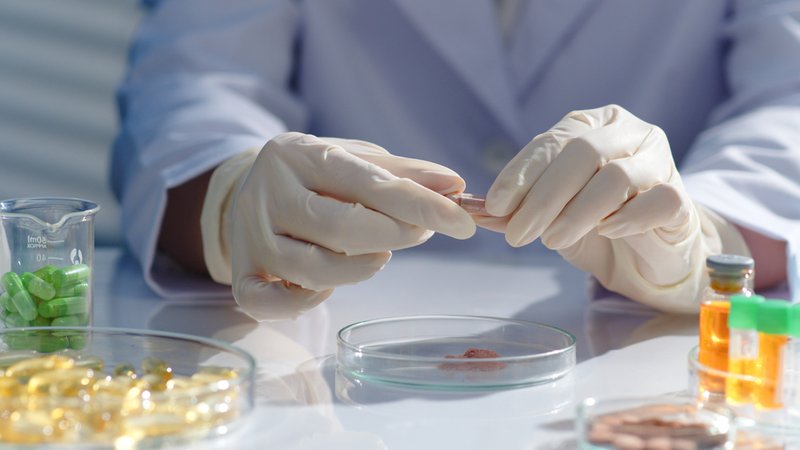 Lab tester performing supplement testing on new products