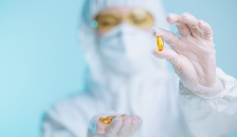 Pharmaceutical worker holding a capsule supplement