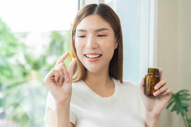 Woman about to take clean label supplements.