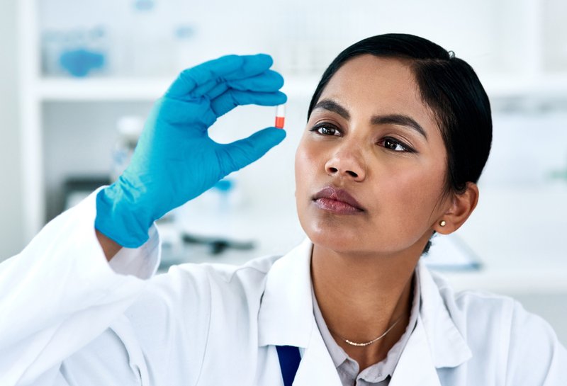 Supplement manufacturer inspecting a capsule