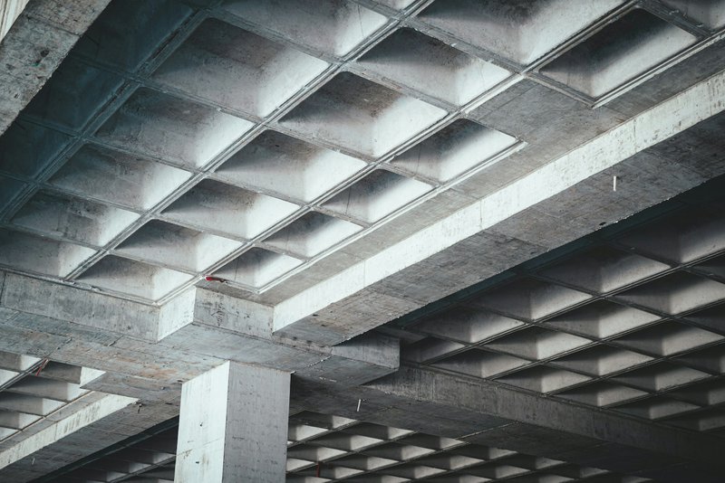 the underside of an overpass with a stop sign
