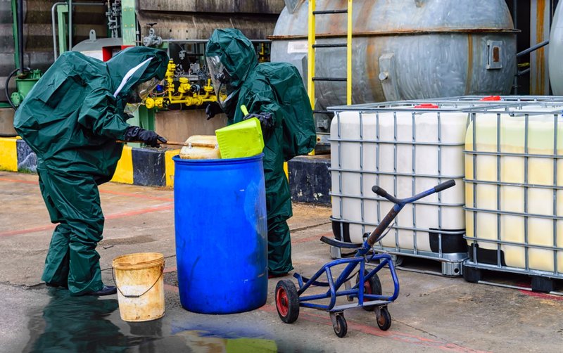 Industrial accident cleanup crew in a factory.