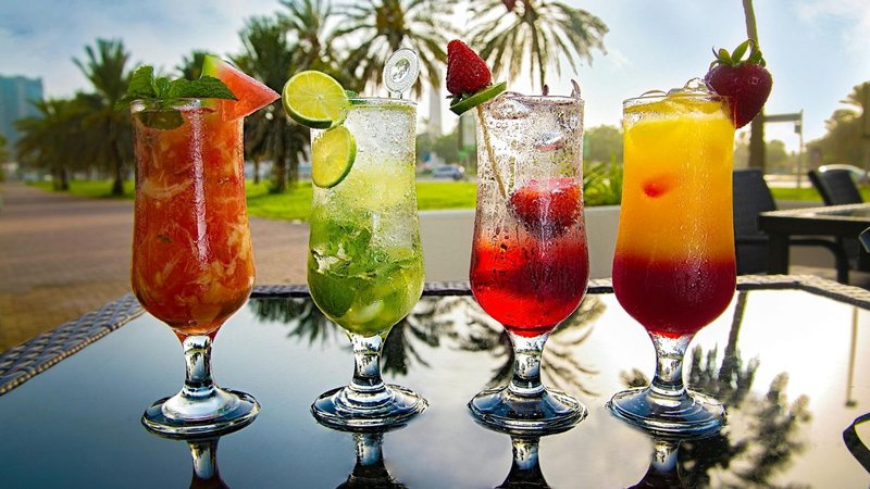 Assorted chilled fruit drinks with fresh garnishes, perfect for exploring different tropical flavor profiles.